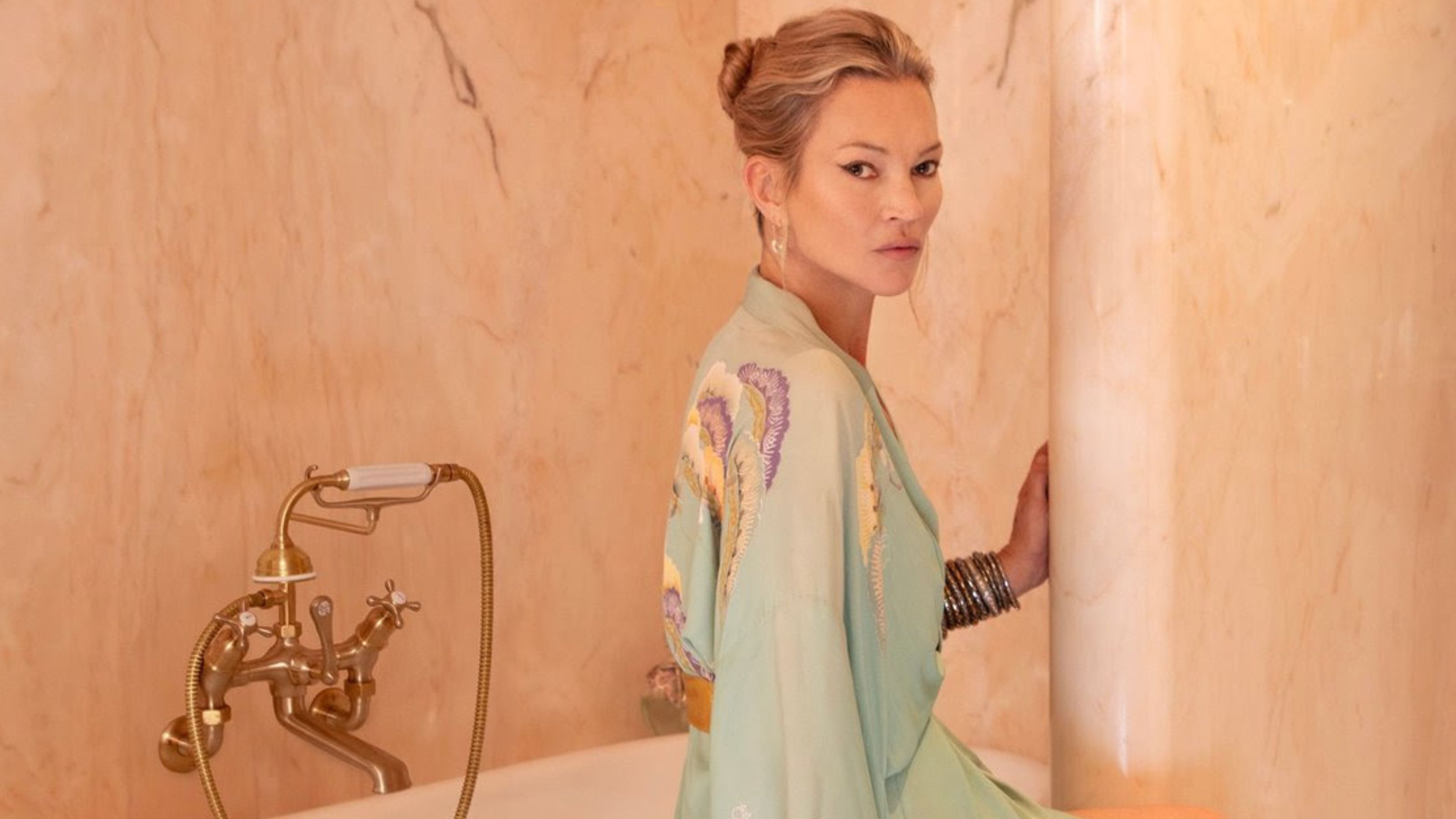 Kate Moss sits in her luxury bathroom that is drenched in pink marble