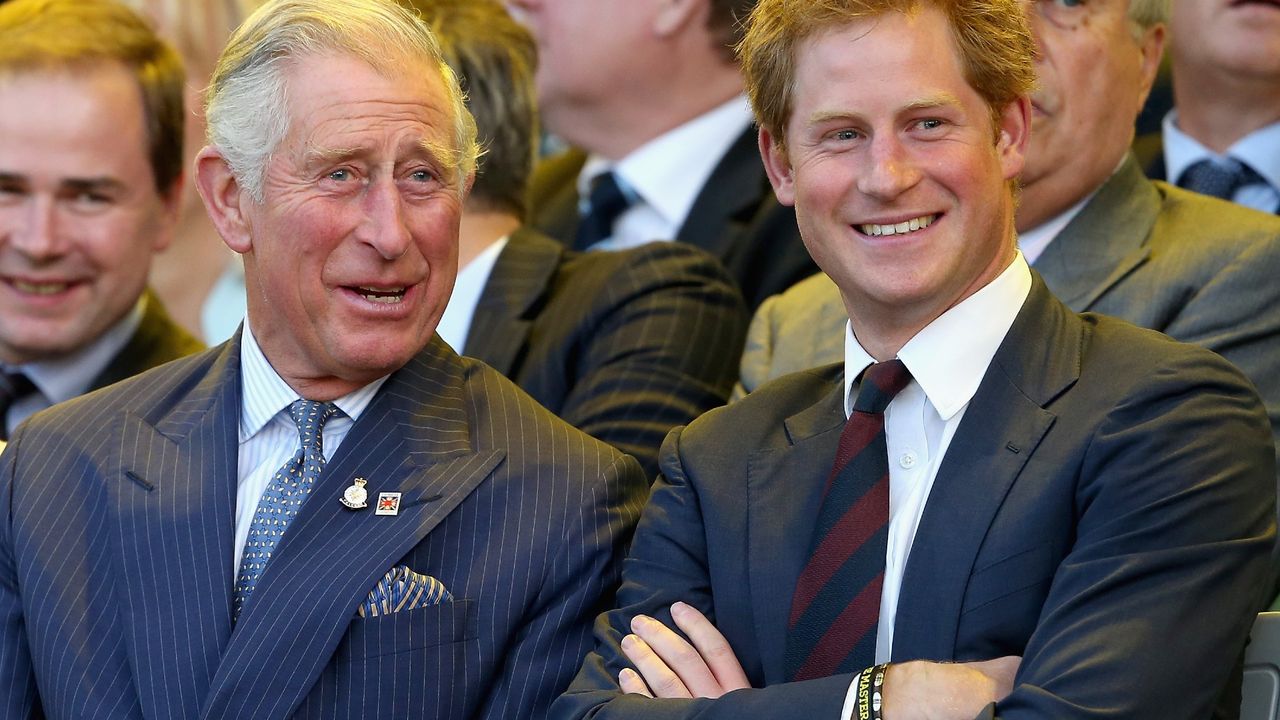 Prince Charles, Prince of Wales and Prince Harry laugh during the Invictus Games Opening Ceremony on September 10, 2014 in London, England. The International sports event for &#039;wounded warriors&#039;, presented by Jaguar Land Rover