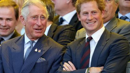 Prince Charles, Prince of Wales and Prince Harry laugh during the Invictus Games Opening Ceremony on September 10, 2014 in London, England. The International sports event for 'wounded warriors', presented by Jaguar Land Rover