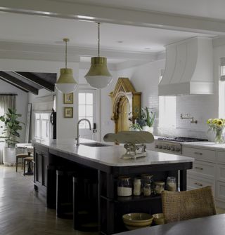 white kitchen with kitchen island pendant lighting by AHD&Co
