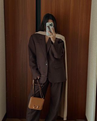 @bettinalooney wearing a brown suit