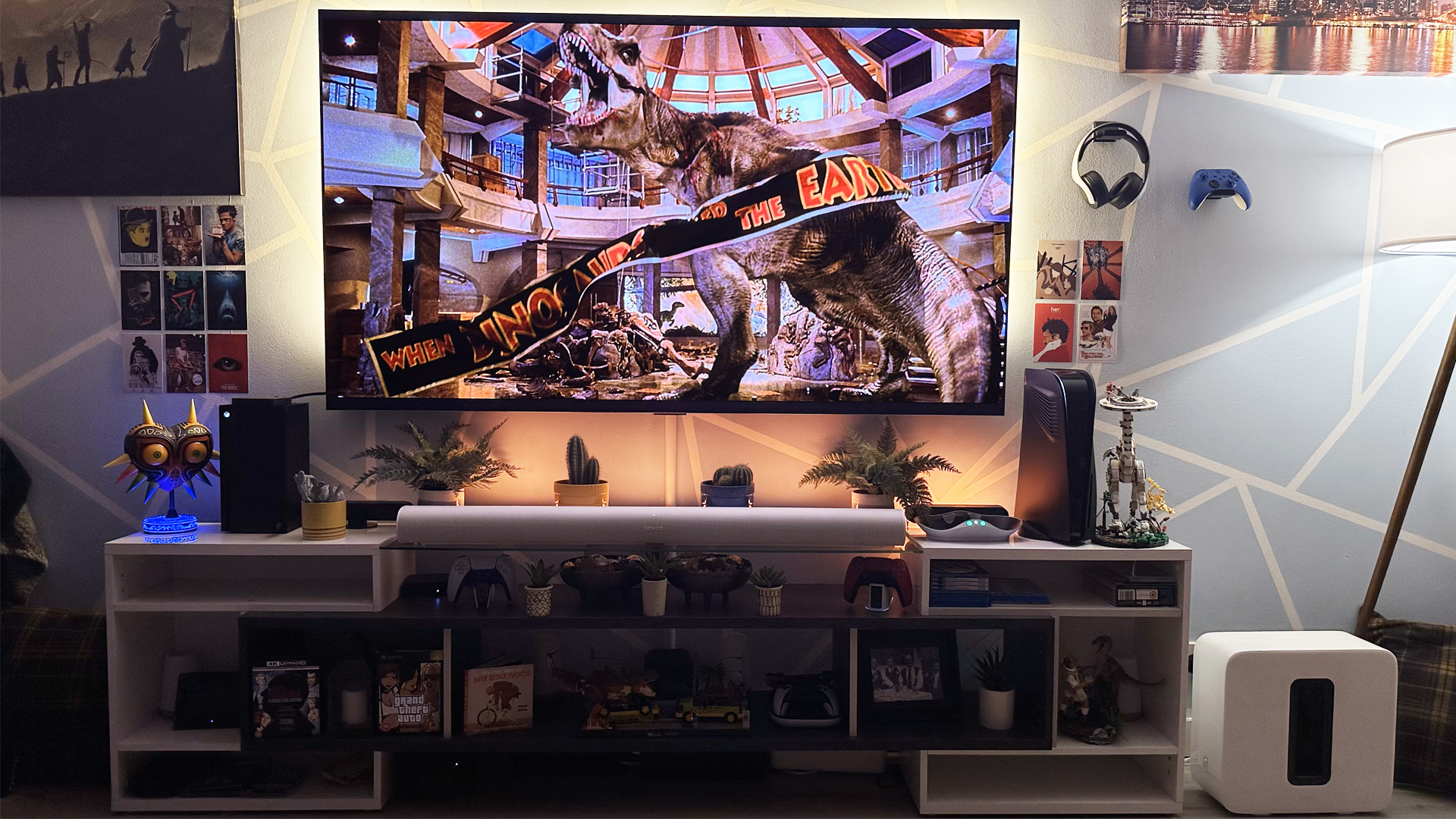 An LG G3 TV showing the movie Jurassic Park with a Sonos Sub nearby
