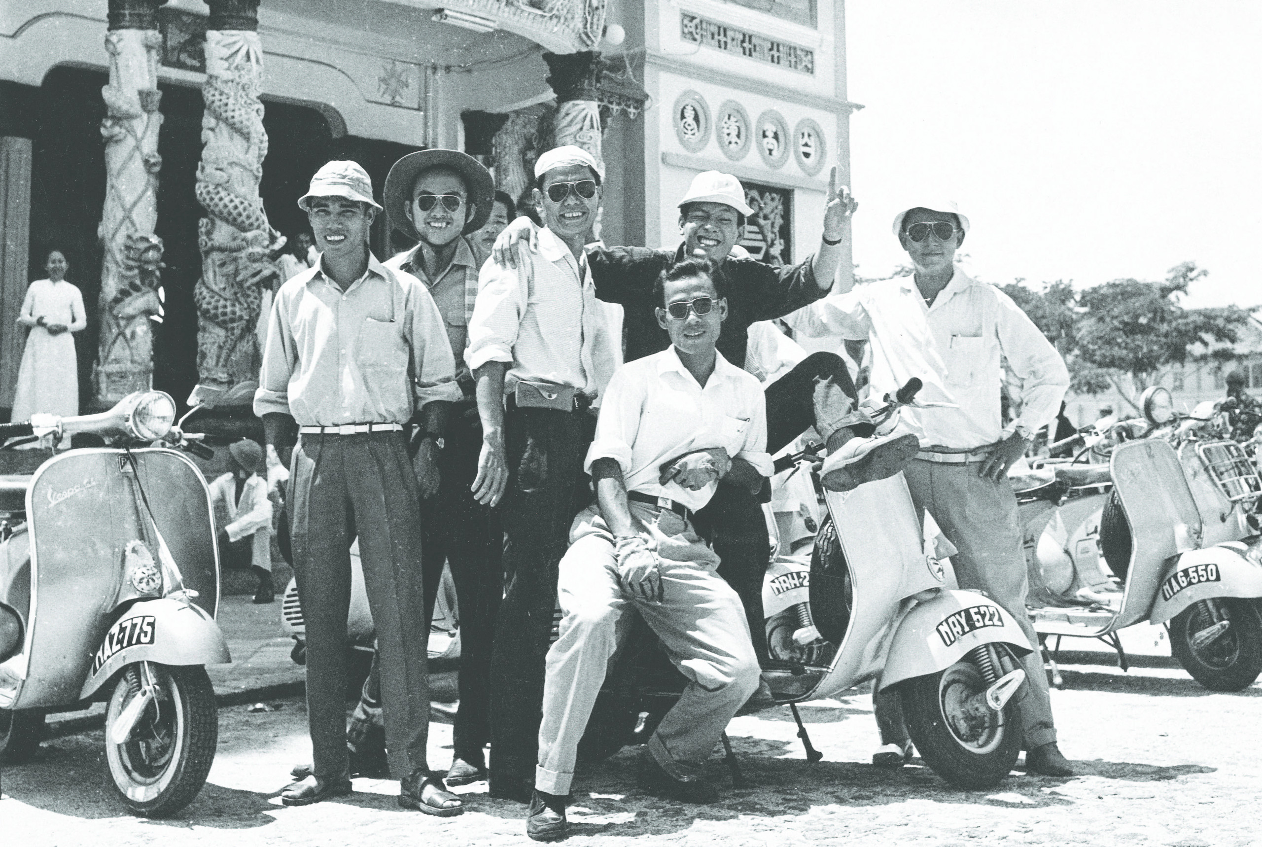 A group of dashing Vespa enthusiasts pause during a journey through Vietnam