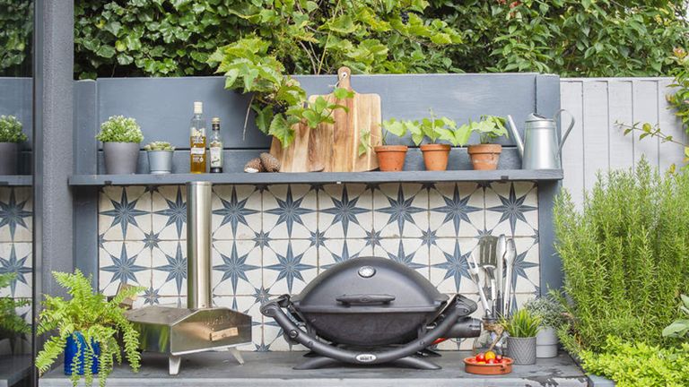 A bbq with blue and white tiled surface 