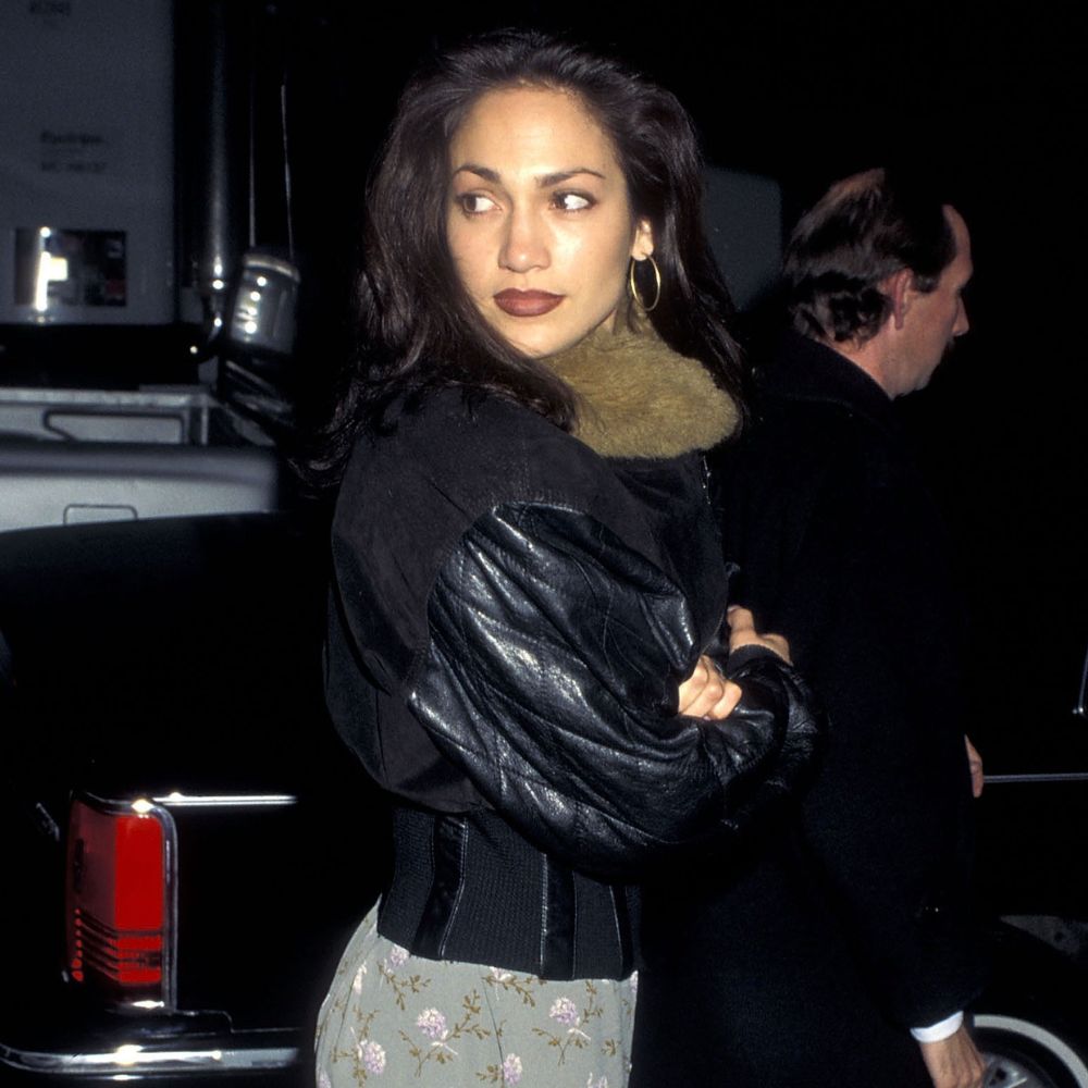 Jennifer Lopez wears a floral maxi skirt with platform heels and a leather jacket.