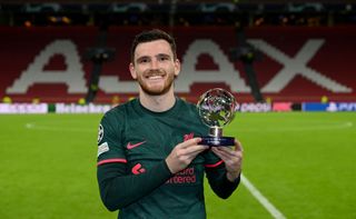 Andy Robertson of Liverpool with the Player of the Match trophy at the end of the UEFA Champions League group A match between AFC Ajax and Liverpool FC at Johan Cruyff Arena on October 26, 2022 in Amsterdam, Netherlands.