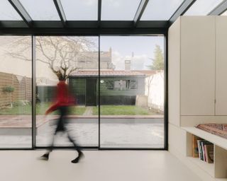 inside a minimalist french home interior looking out towards a garden