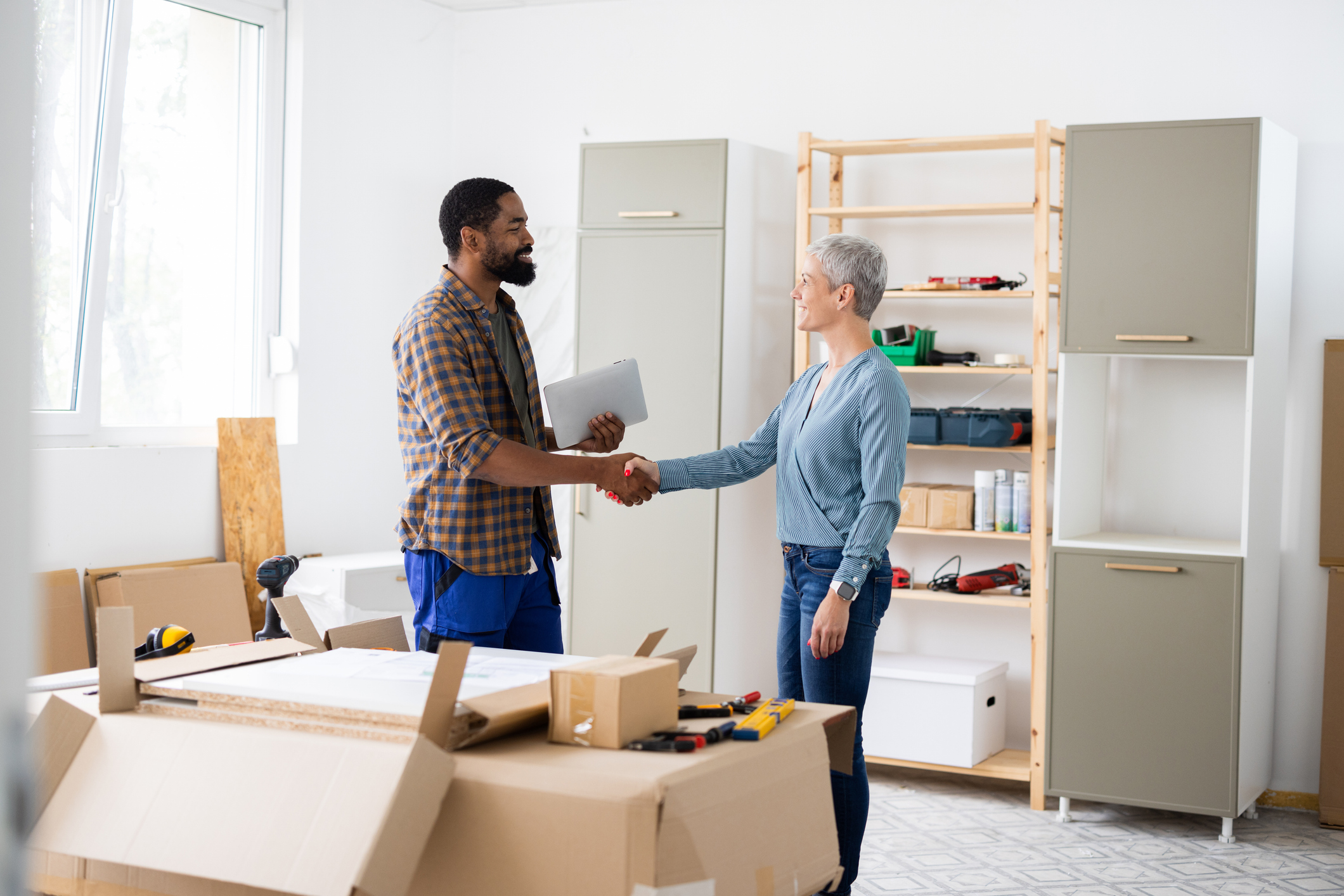 Carpenter shaking hands with client