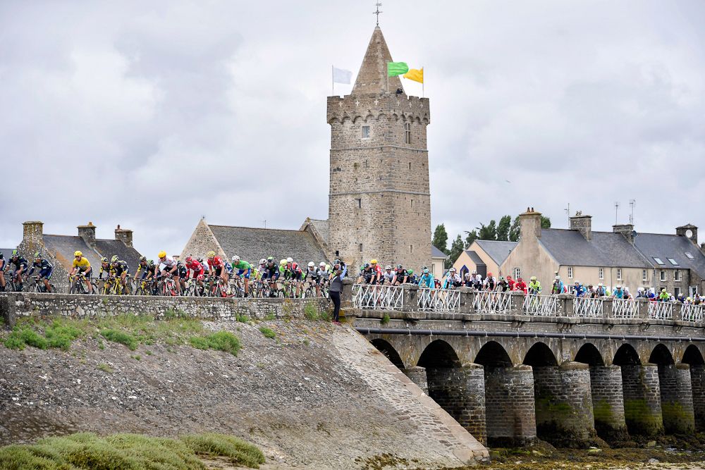 The peloton crosses a bridge during stage 2 at the Tour de France