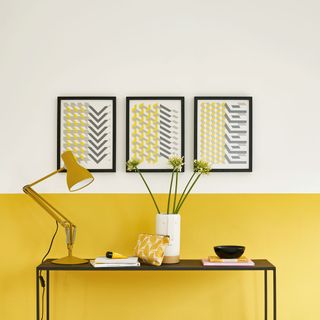 room with yellow wall and yellow lamp and picture frame and table