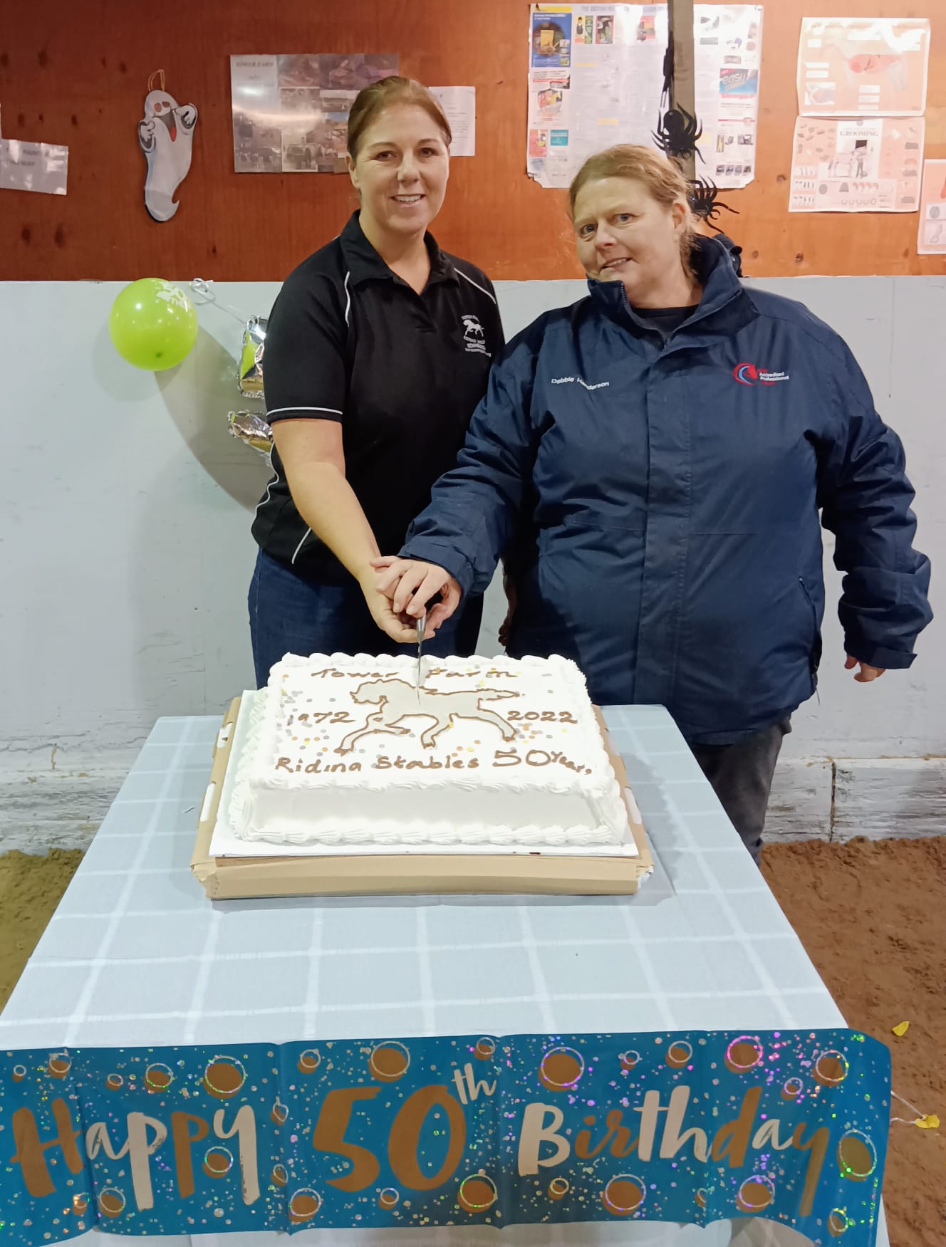 Tower Farm riding school owner Caroline Buckle and yard manager Debbie Henderson cut the cake to mark the centre&amp;rsquo;s 50th birthday