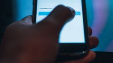 person signing into an app on their smartphone