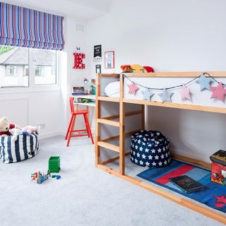 white kids room with wooden bunk bed and striped blind