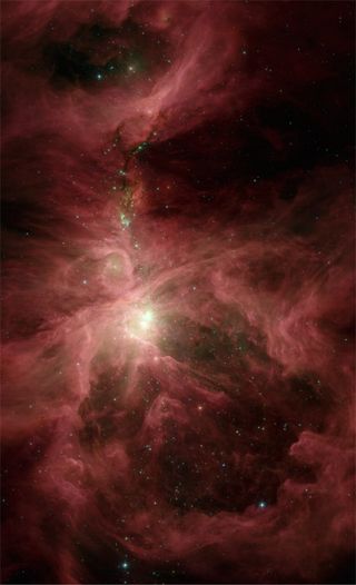 An infrared image of the Orion Nebula, a site of massive amounts of star formation, taken by NASA's Spitzer Space Telescope.