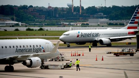 An American Airlines plane and an American Eagle plane pass each other