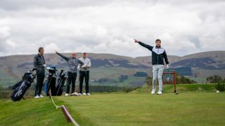 A golfer signalling his ball is heading right on a hole at Gleneagles