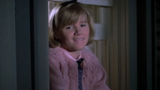 Mare Winningham in a pink sweater, smiling in St. Elmo's Fire