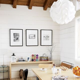 dining area with white wall and dining table