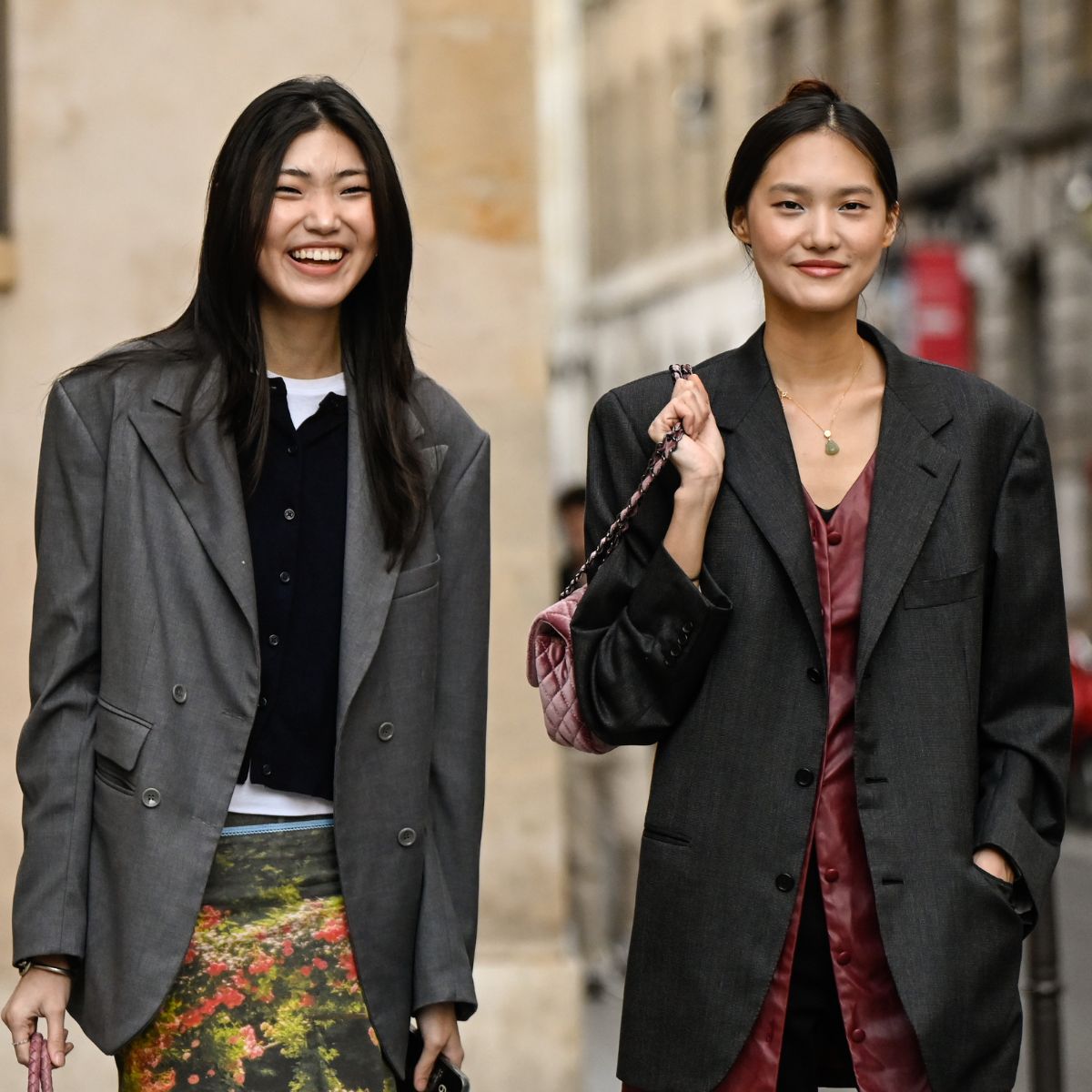 street style shot of two women wearing grey blazers in paris