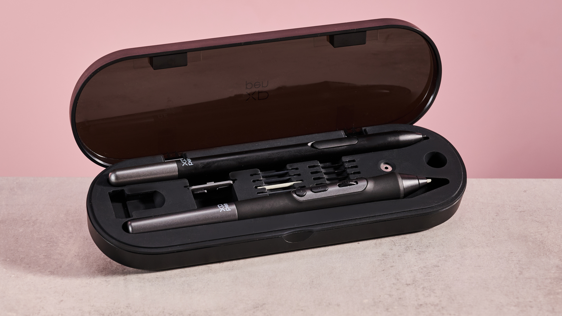 A closeup of the XPPen Artist Pro 19 Gen 2's stylus case in front of a pink background.