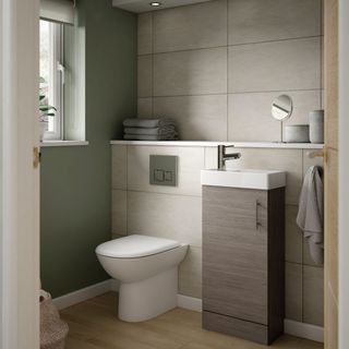 slimline sink and cupboard unit in shower room with toilet