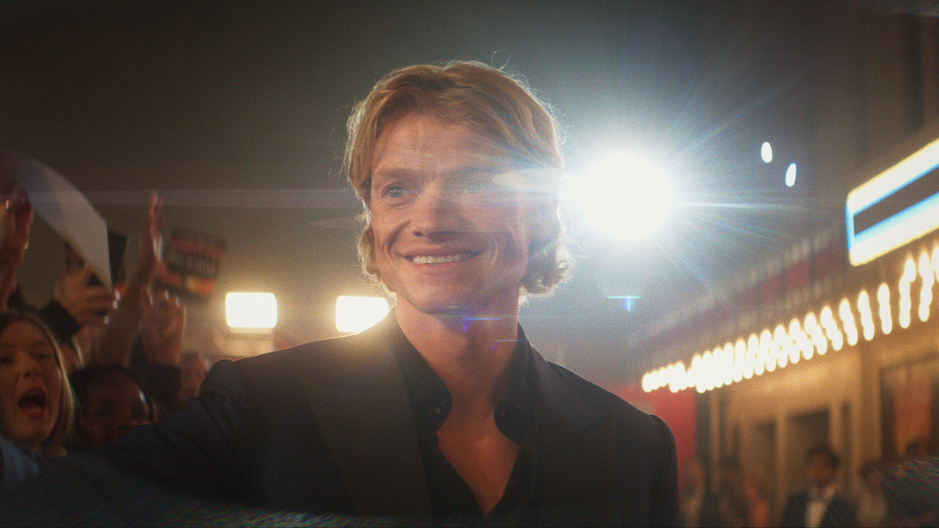 Matt Hagen smiling and posing for photographs on a red carpet in Clayface