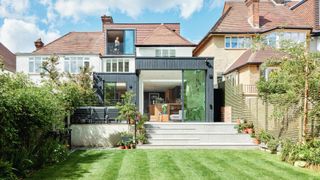 Rear elevation of family hone converted from two flats with outwards extension and lawn