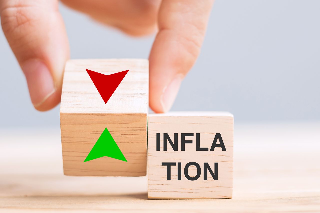 Hand change wood cube block with INFLATION to UP and Down arrow symbol. Interest rate, Economy RECESSION, stocks, financial, mortgage, Crisis and Cut loss concept