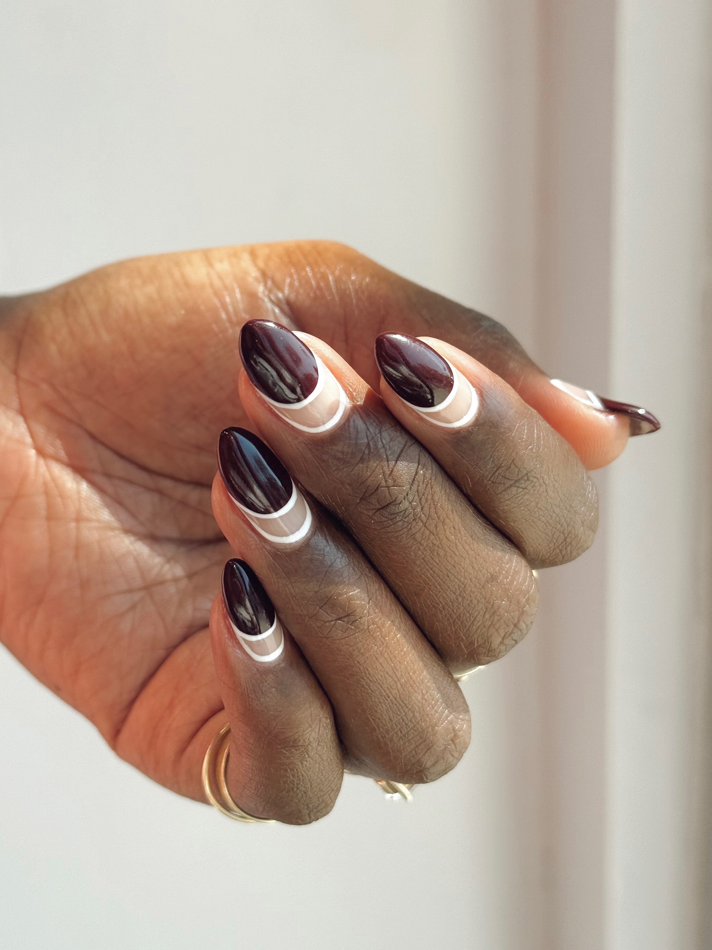 A manicure by Queenie Nguyen with maroon tips