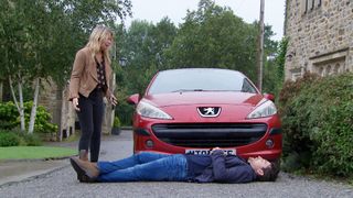 Mack Boyd lies in front of Charity Dingle's car.