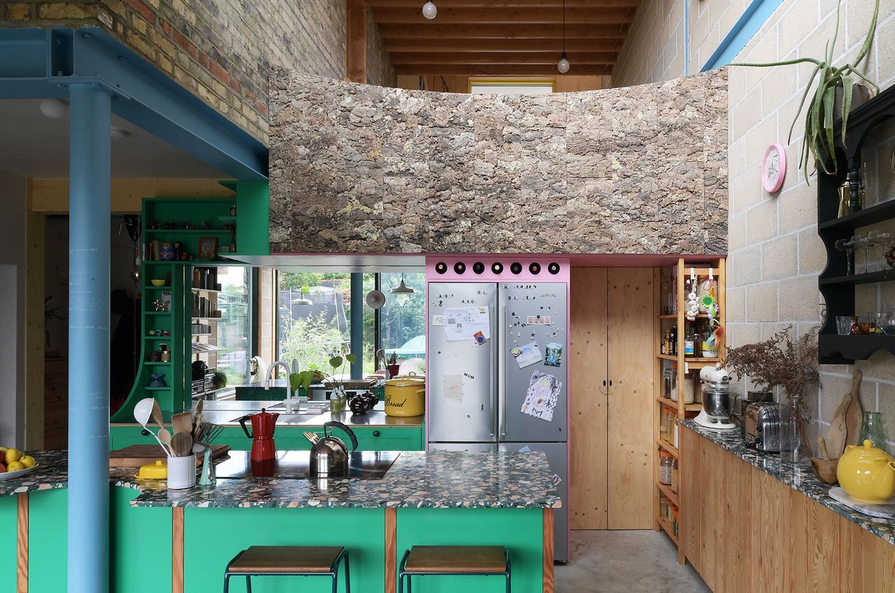 Kitchen at Forest House with granite counter, bar stools, a fridge and appliances