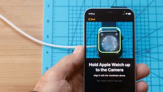 Close up of an Apple Watch 10 sitting on a light blue mat showing the setup screen