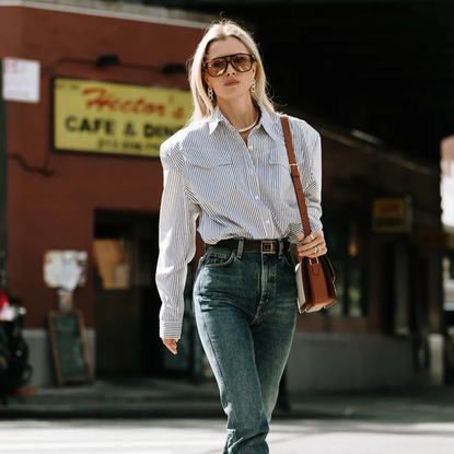 Woman wearing striped button-down, high-waisted jeans and a thick belt in New York