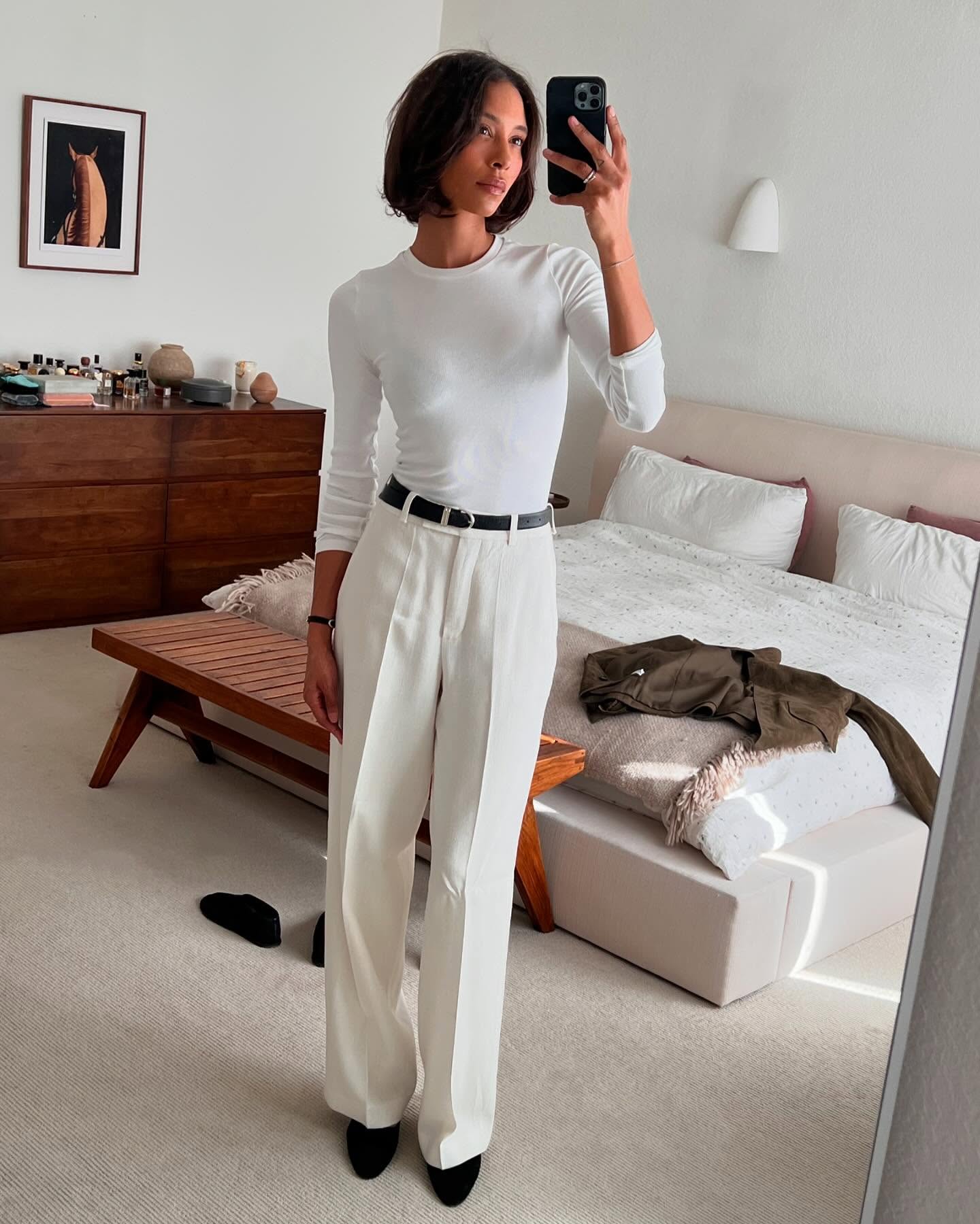 An image of TyLynn Nguyen wearing wide-leg trouses with a crew-neck top.