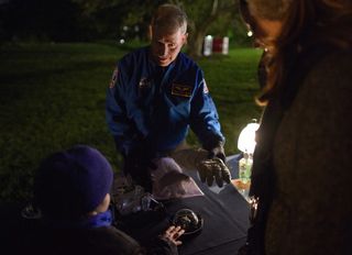 John Grunsfeld, NASA associate administrator for the Science Mission Directorate, showed off a spacesuit glove at one of the White House Astronomy Night science activity stations on Oct. 19.