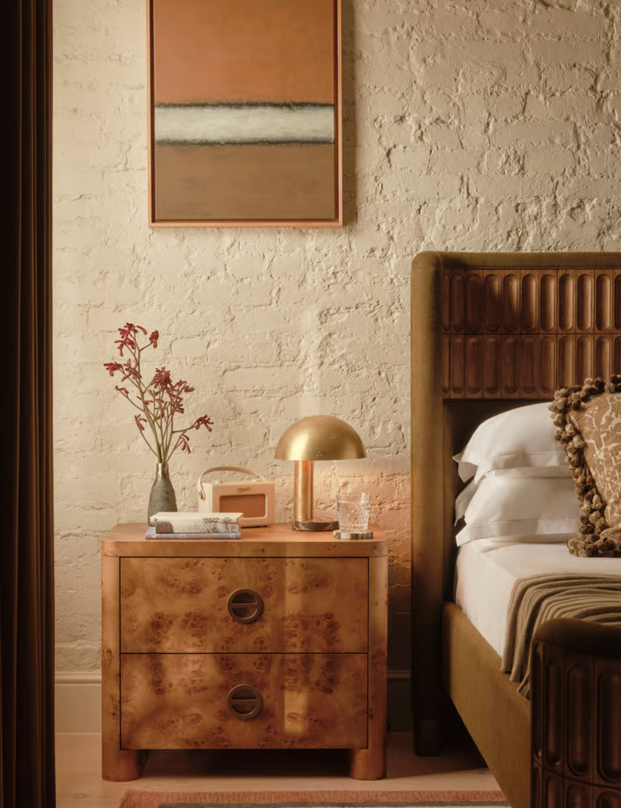 Burlwood nightstand in a mid-century-style bedroom with a warm neutral color palette