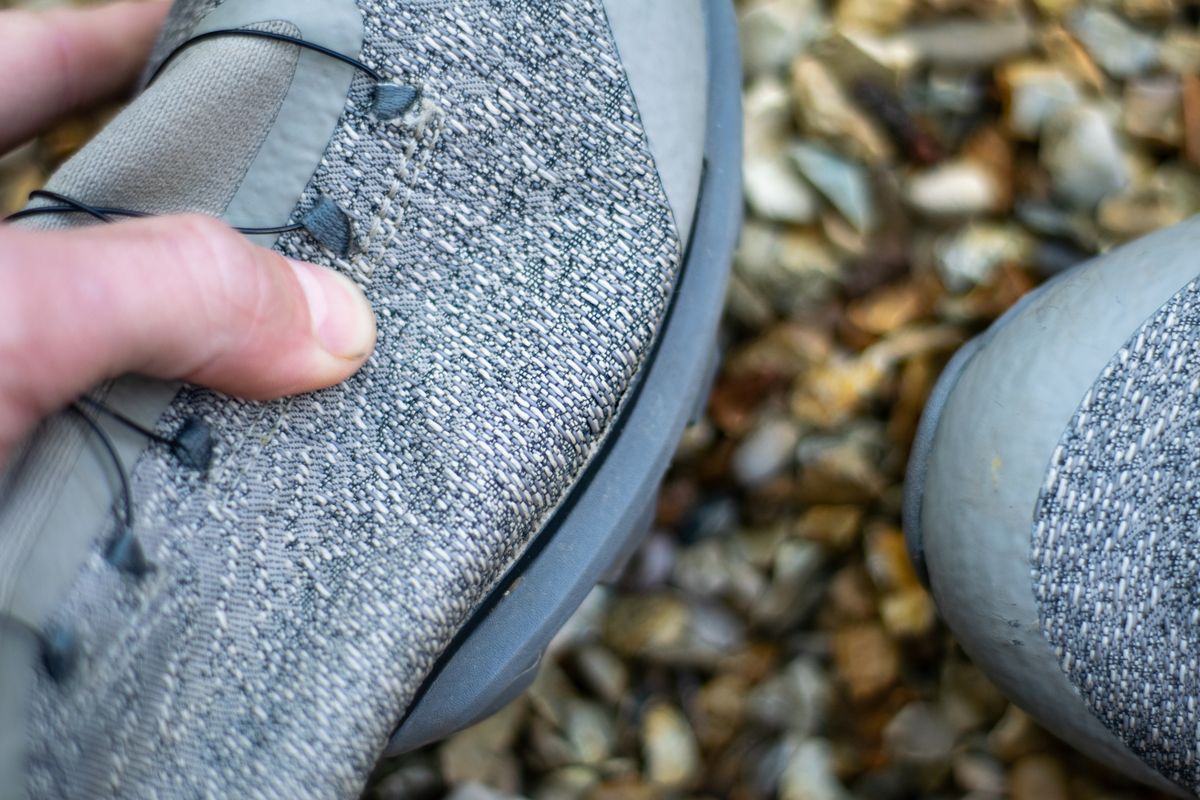A pair of Rapha Pro Team Gravel shoes on some gravel