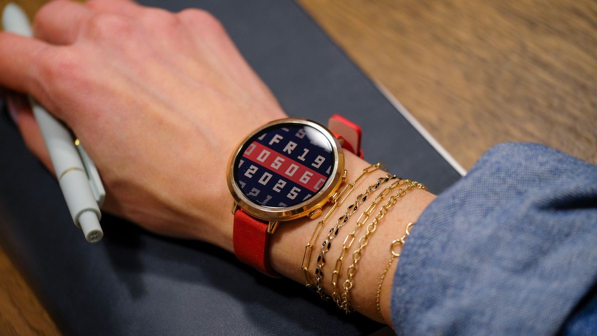 Photo of the Pebble Round 2 worn on a wrist surrounded by bracelets.