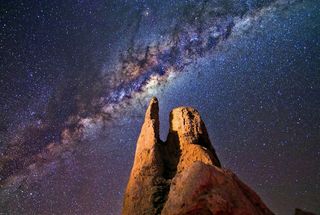 Dramatic night sky photo with foreground rocks