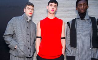 Three male models wearing clothing by Chalayan.