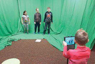 Students engaged in a green screen activity.