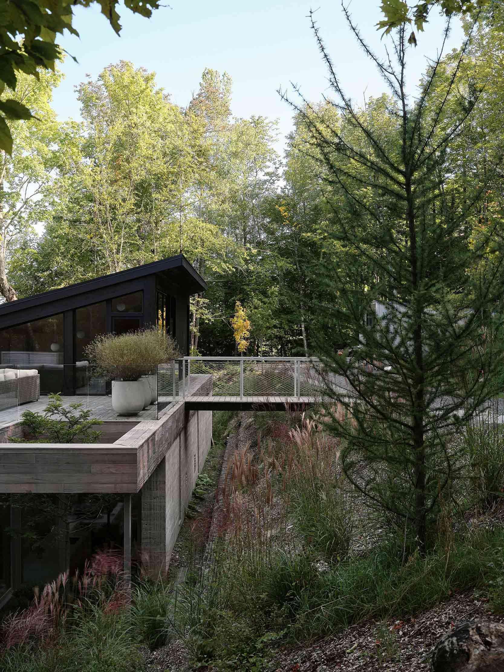 The house is accessed via a bridge to the top level