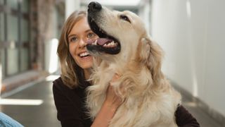 Woman petting Golden Retriever