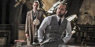 Albus Dumbledore perches on his desk in a scene from 'Fantastic Beasts: The Crimes of Grindelwald'