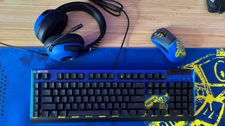 Razer Fortnite special edition keyboard, mouse, headset, and mouse pad on a wooden desk