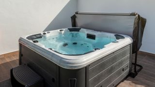 Luxury bathtub, for therapeutic massage and relaxation outside on the grass. Under the blue sky.