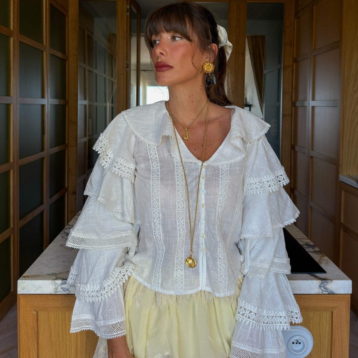 Jules wearing white blouse