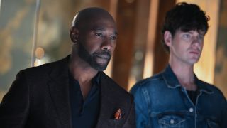 Morris Chestnut in a button down standing next to one of his employees in Season 1 of Watson.