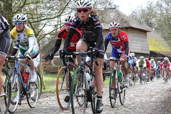 The peloton rides the cobblestones.