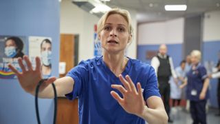 Niamh Algar in blue scrubs as Dr Lucinda Edwards in Malpractice.